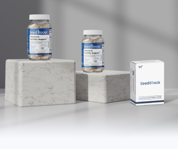 SeedBoost supplement bottles and SeedCheck male fertility test kit displayed on marble stands