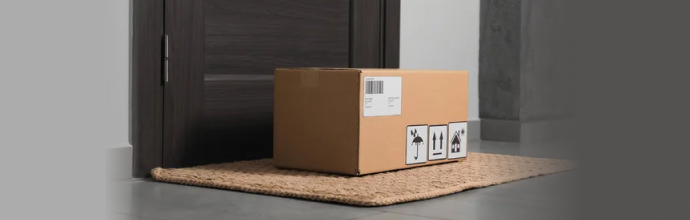 Discreet cardboard package delivered on a home's front doormat